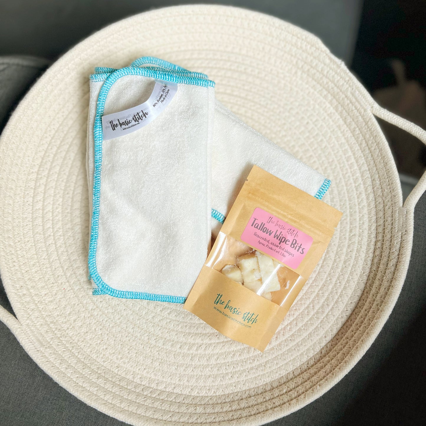 Bamboo Terry cloth wipes and tallow wipe bits. Blue edge stitch on a white cloth. Featured on a cream colored woven rope basket.