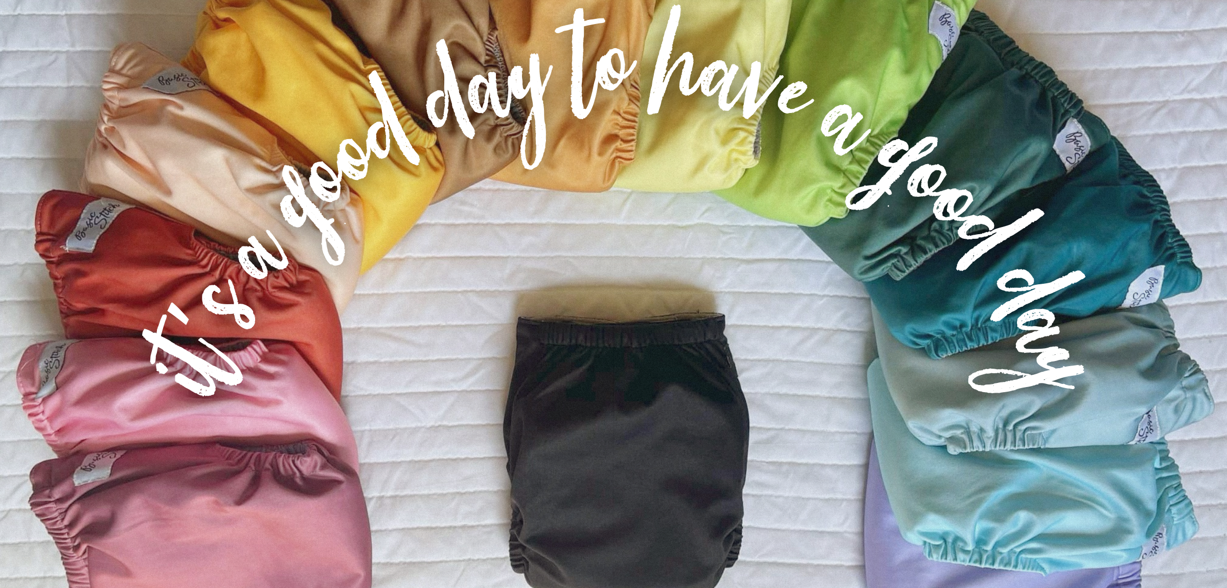 It's a good day to have a good day. Array of colorful Cloth diapers in a rainbow shape.